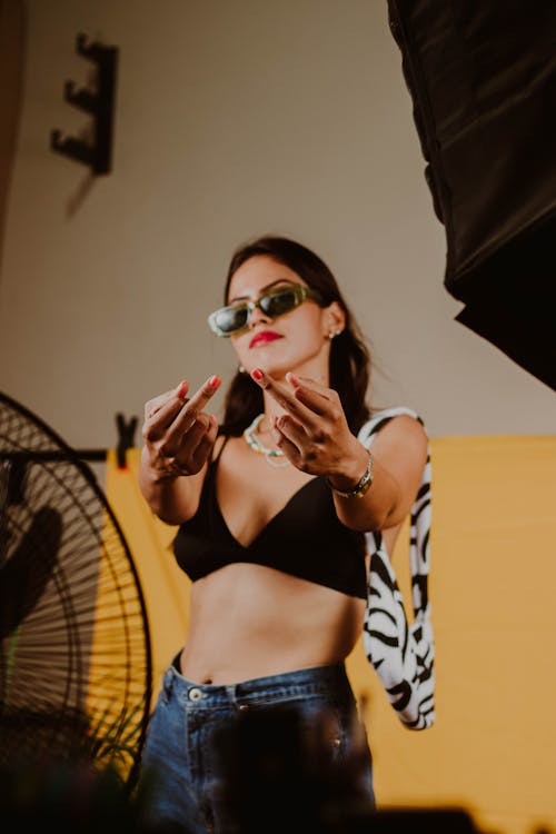 A Woman in Sunglasses Making Hand Sign