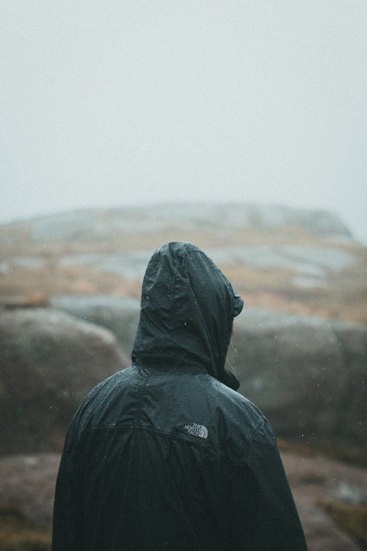 Person In Waterproof Jacket On Rocks