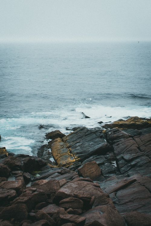 Free Explore the rugged coastal rocks and sea waves in a dramatic, moody setting. Stock Photo