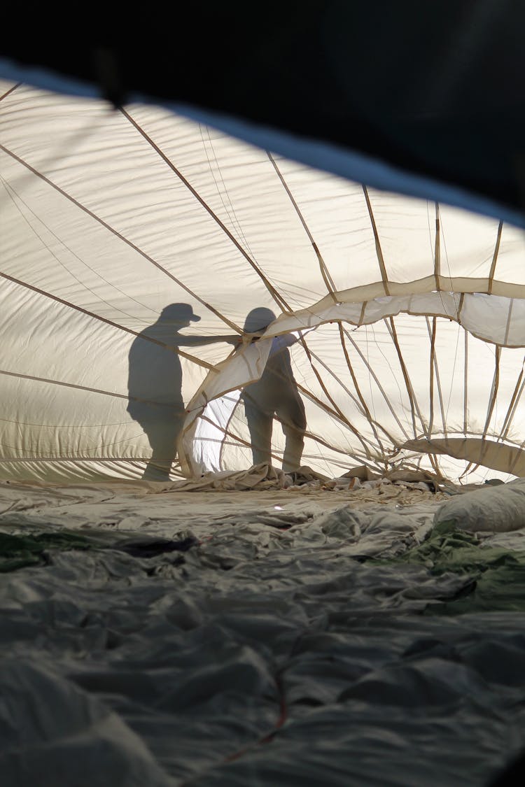 Photo Of A People Silhouette Working On Hot Air Balloon