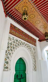 Beautiful Moroccan doorway with elaborate designs and a vibrant green door, showcasing traditional architecture.