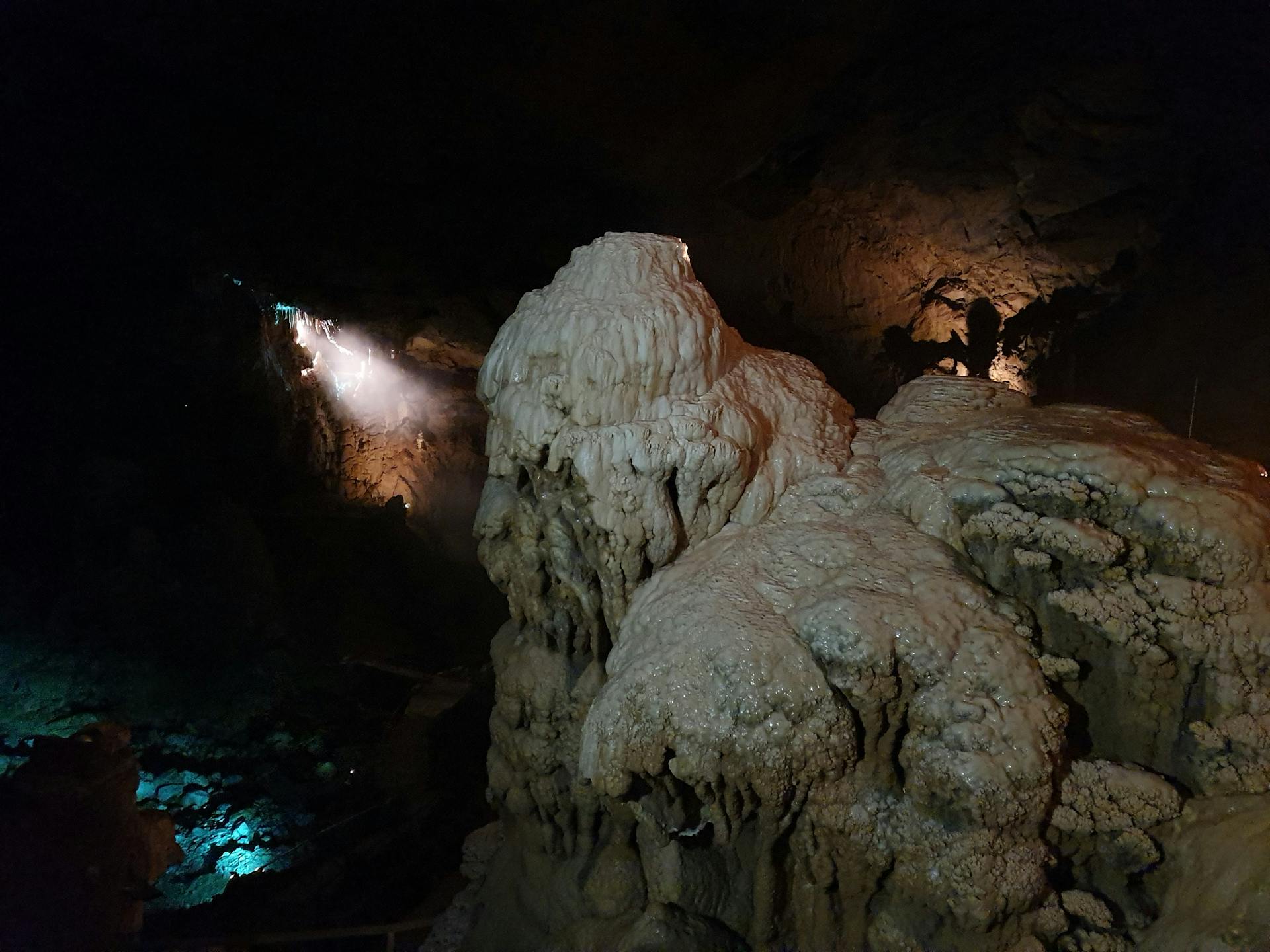 Explore the stunning limestone formations and geological marvels hidden in this mysterious cave setting.