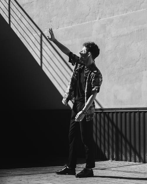 Black and White Photo of Man Reaching Out