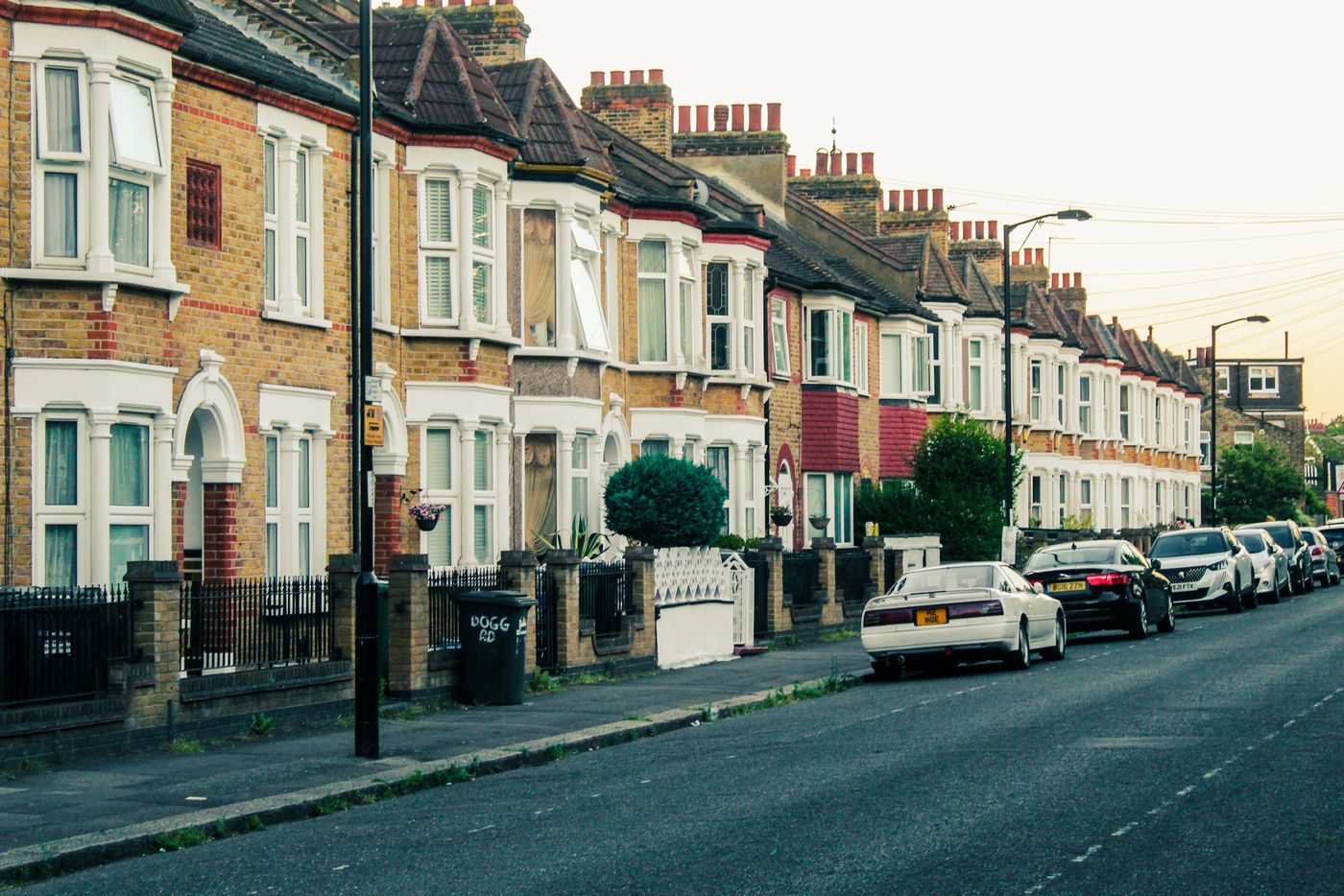 Traditional terraced houses along a quiet English street at dusk