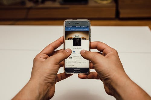 Person Holding Silver Smartphone