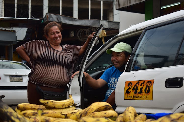 Photo Of A Woman With A Taxi Driver 