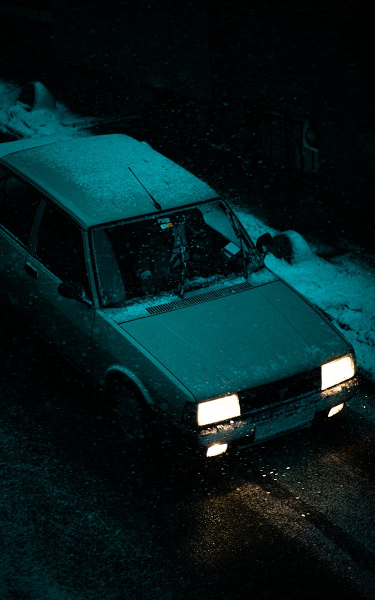 Old Car Driving At Night In Winter