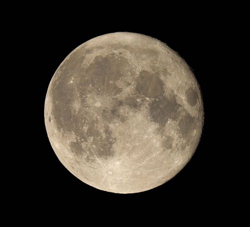 Free Close-up of a full moon showcasing lunar surface details against a black sky. Stock Photo