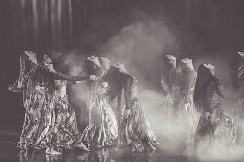 Monochrome Photography of Women Performing On Stage