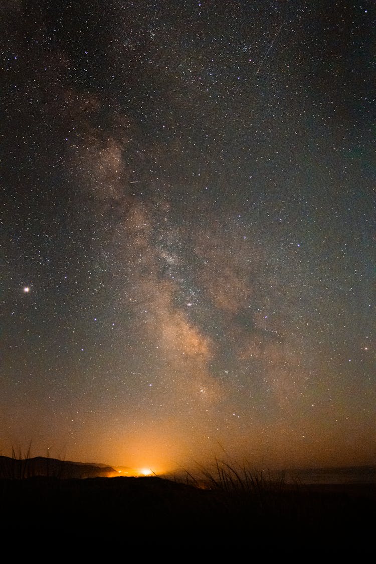 Galaxy On The Sky Above Sun Setting Over A Meadow