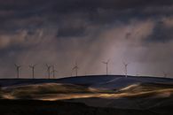 Wind Turbines on Brown Field Under Gray Clouds