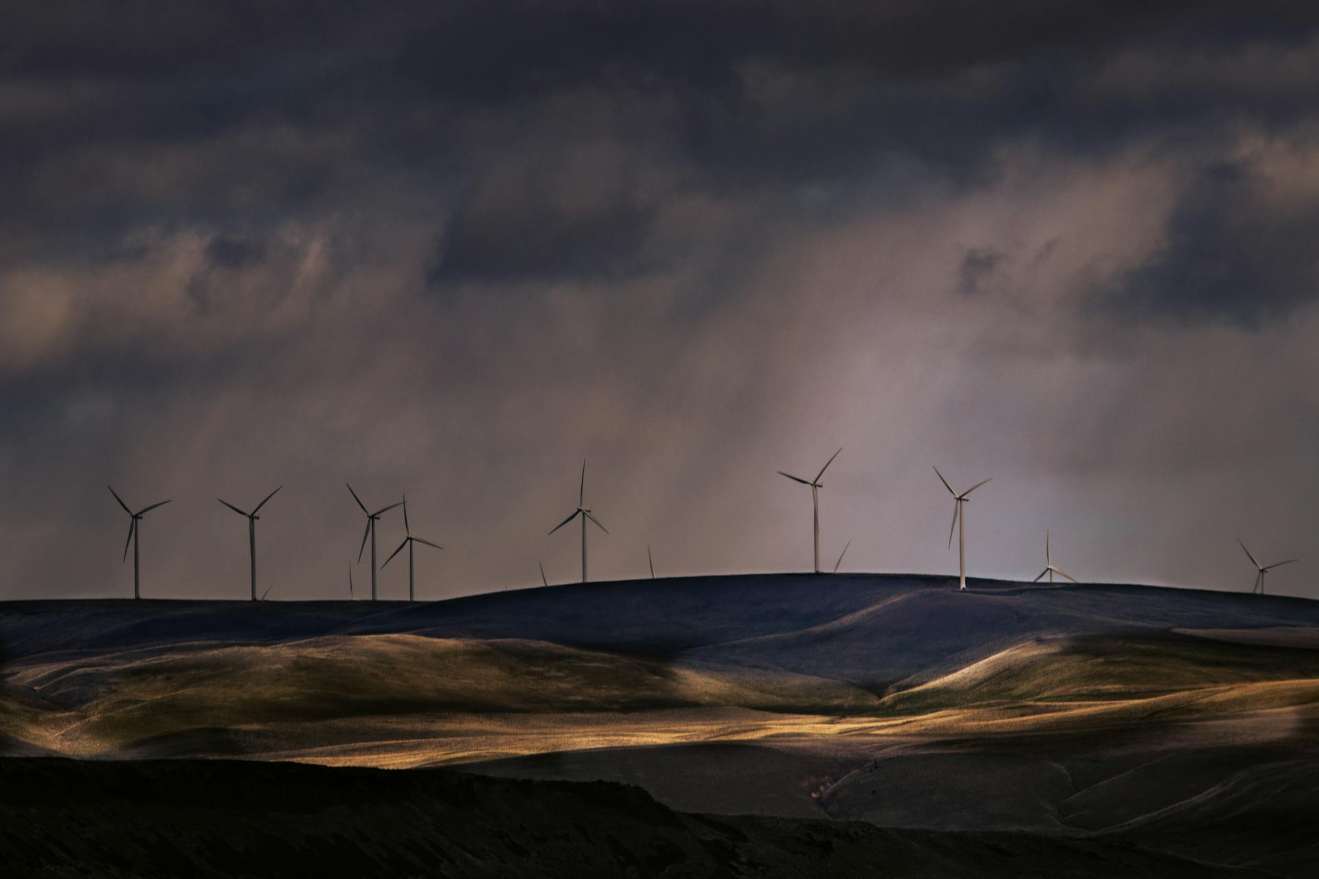 Clouds and Rain over a Wind Turbine Farm on the Hills