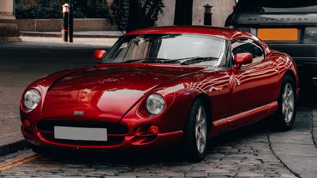 Capture of a striking red sports car parked elegantly on a cobbled urban street.