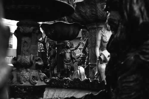Free Black and white photograph showcasing a detailed sculpture fountain with artistic carvings. Stock Photo