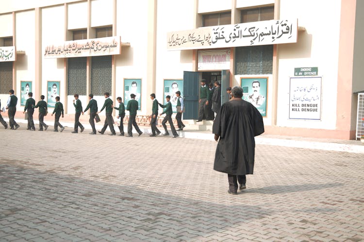 Group Of Students Lined Up Outside A School Building