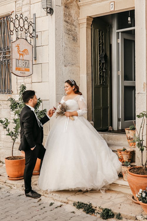 Groom Standing in Front of a Bride