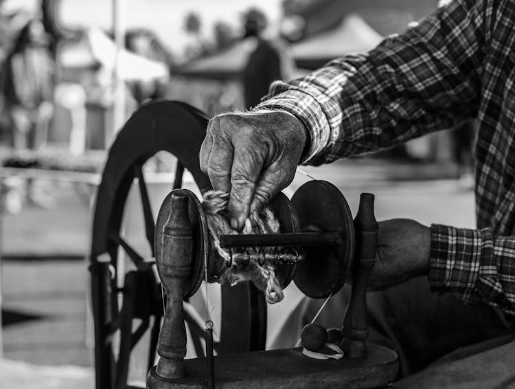 Hands Of An Elderly Man Cleaning A Spinning Yarn