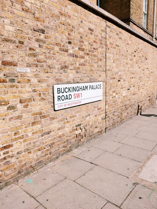 Free A brick wall and street sign on Buckingham Palace Road, City of Westminster, London. Stock Photo