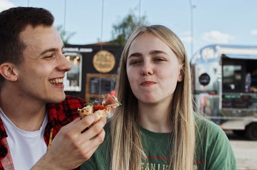 A Couple Eating Pizza