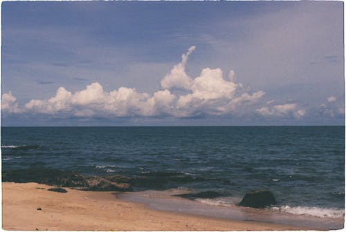 Beach Under a Blue Sky With White Clouds