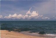 Sea Waves Crashing on Shore Under Blue and White Cloudy Sky