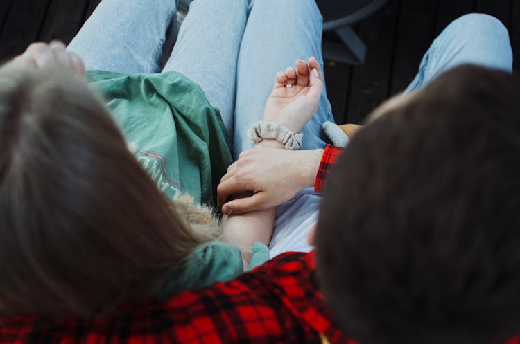 Hand Of A Man On A Woman's Arm