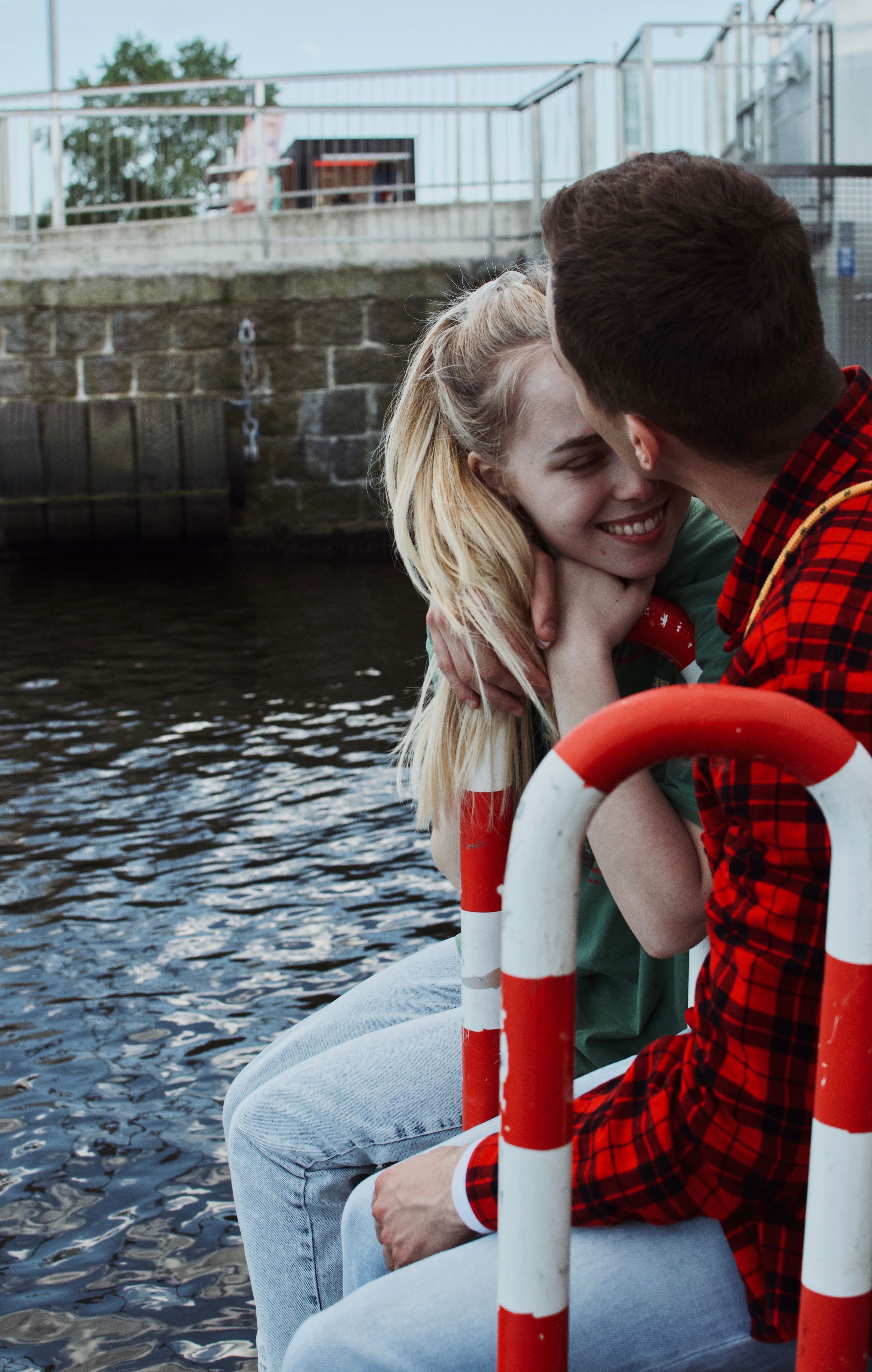 Woman in Leather Jacket Kissing a Man · Free Stock Photo