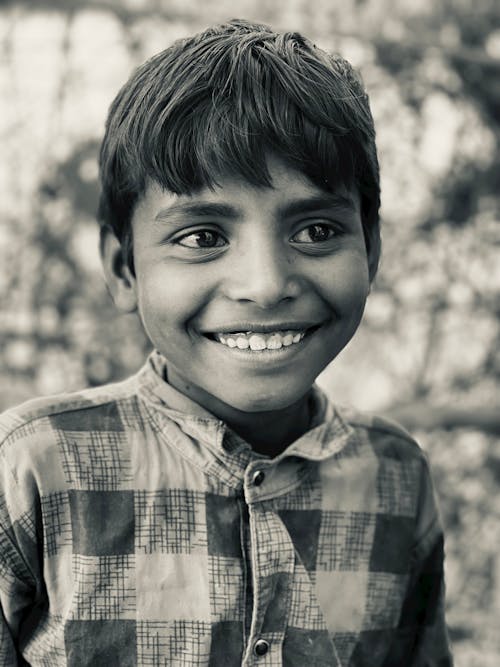 Free Smiling Young Boy Looking Away Stock Photo