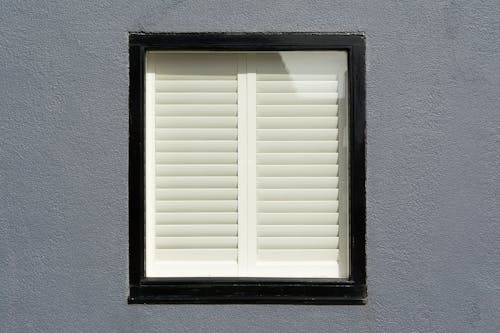 Free A Glass Window with a White Wooden Window Shutter  Stock Photo