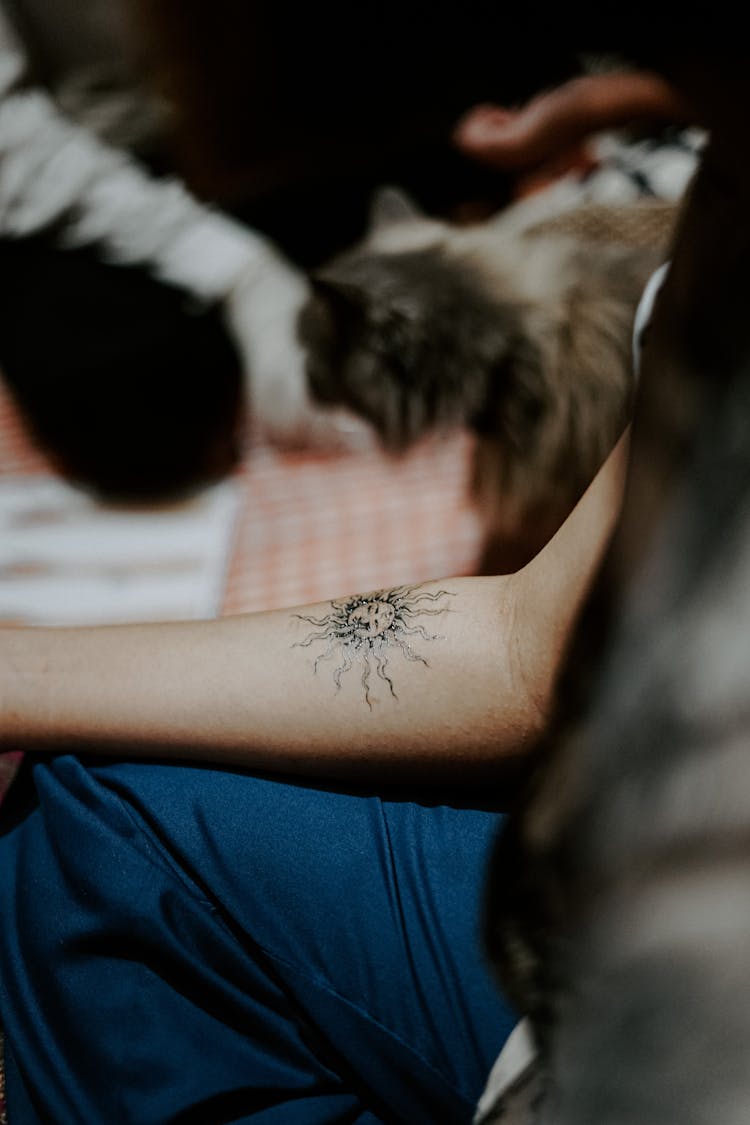 Person With Sun Tattoo On Arm