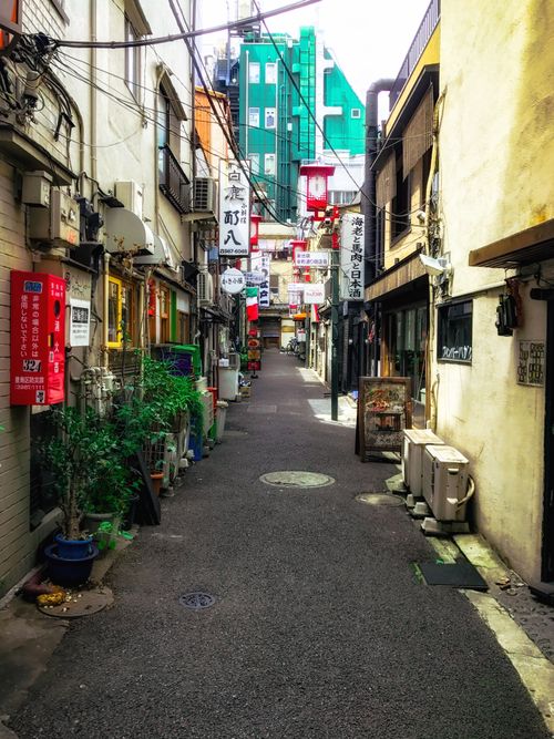 Free Explore a colorful alley in Shinjuku, Tokyo with shops and signage reflecting urban life. Stock Photo