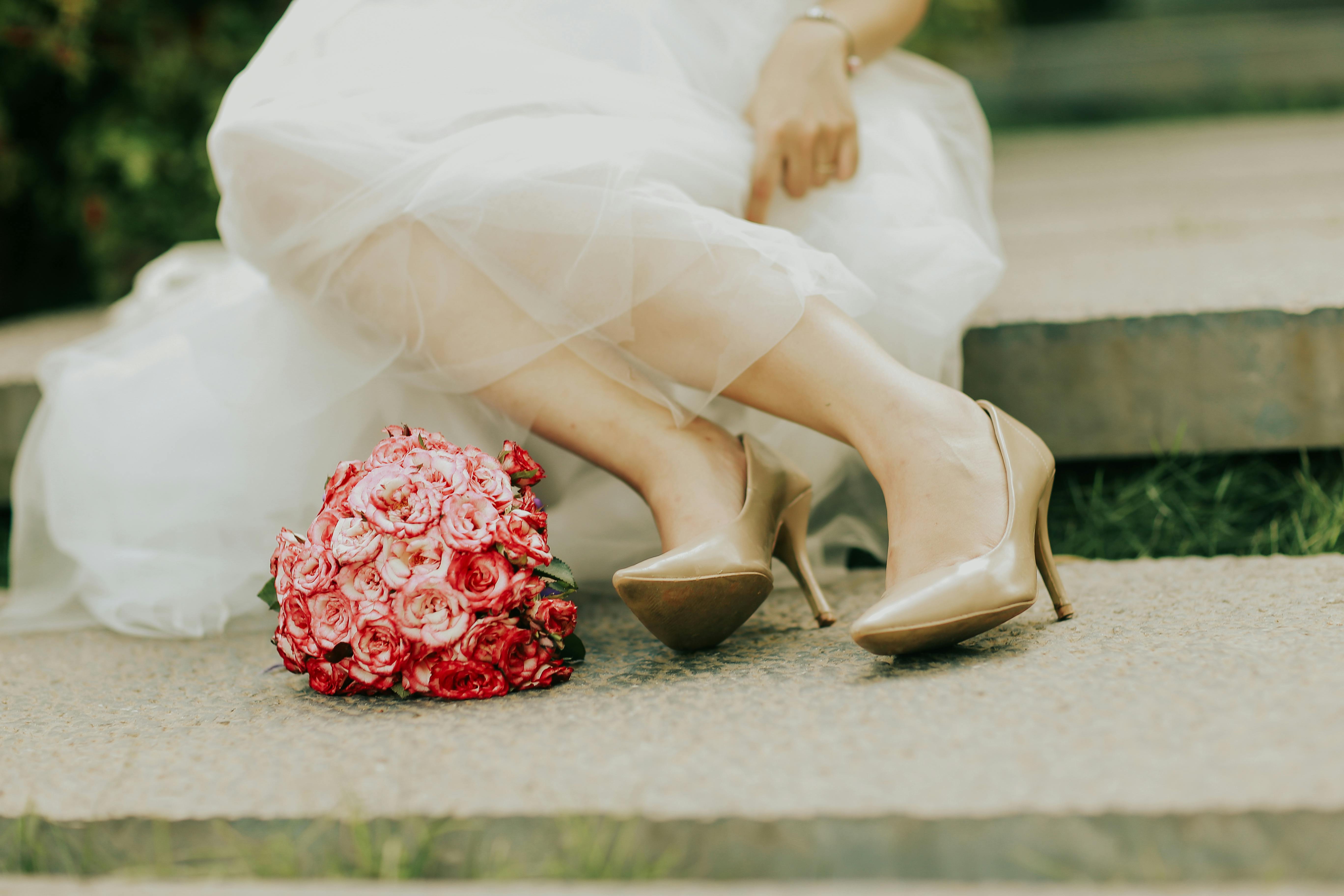 A Woman Wearing Beige Wedding Shoes Free Stock Photo