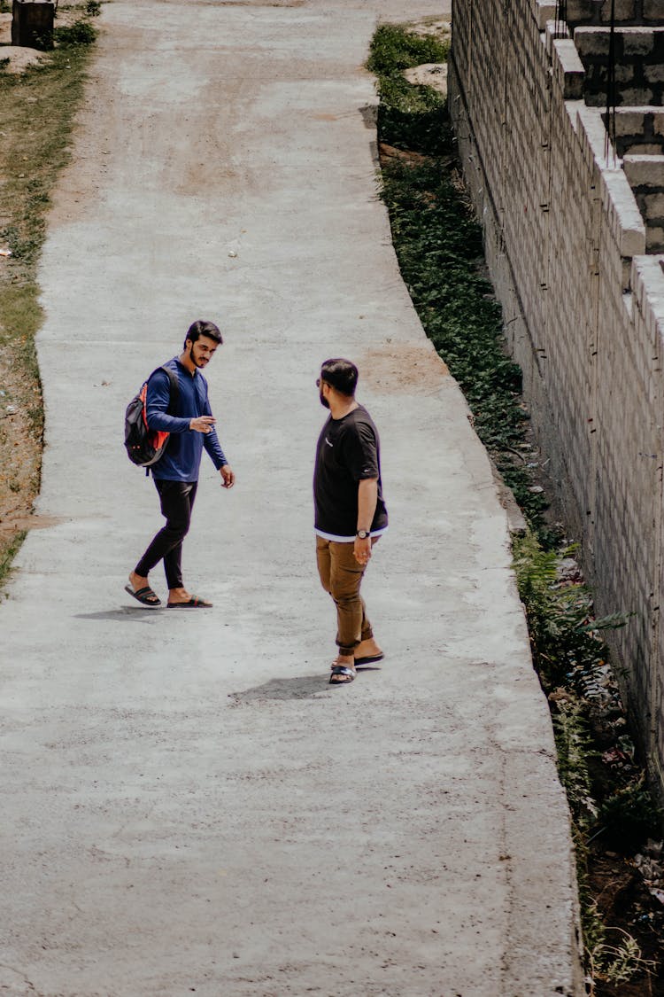 Men Walking On City Path