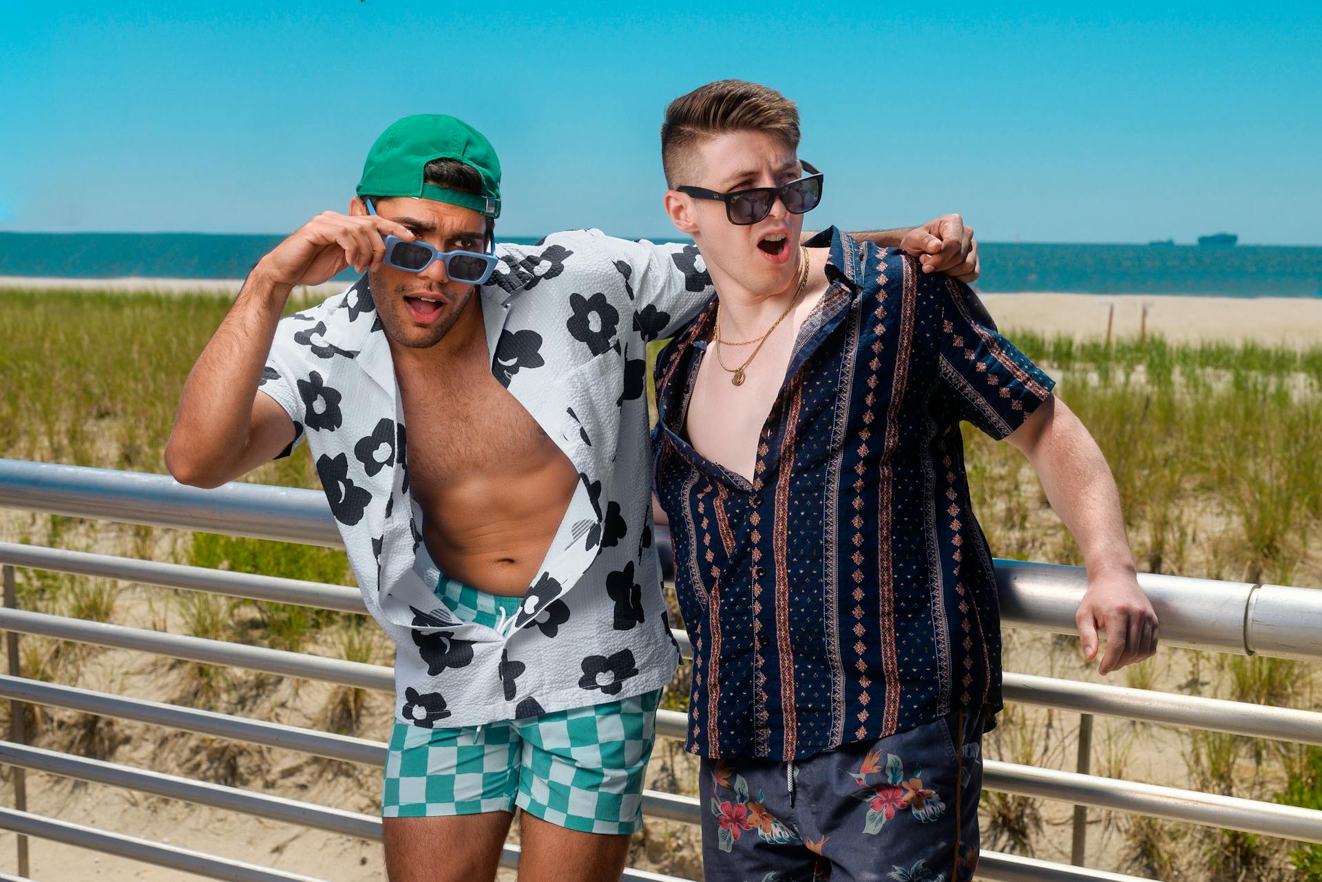 Two young men posing stylishly at Long Beach, NY, enjoying a vibrant summer day.