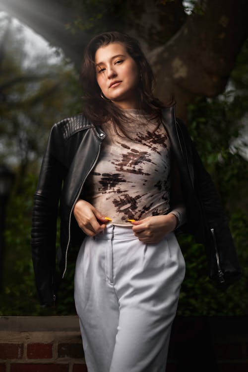 Free A Woman Modeling in a Black Leather Jacket Stock Photo