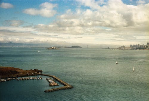 Free Aerial View of Seaport and Seascape under Cloudy Sky Stock Photo