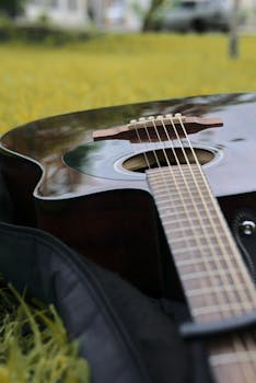 Close-up of an acoustic guitar lying on a grassy field in Michoacán, Mexico.