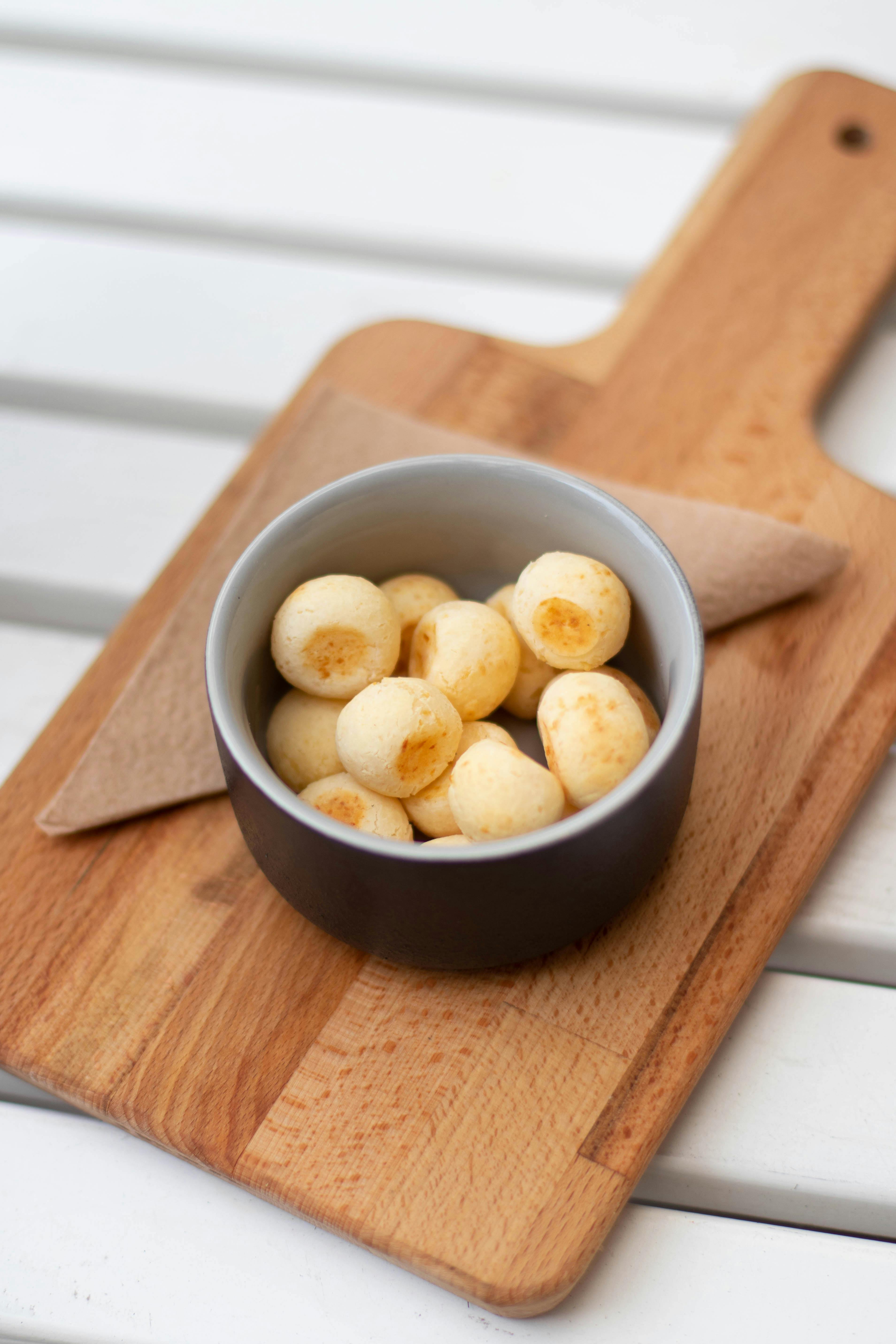 Baked Breads on Round Black and White Ceramic Bowl on the Top of Brown
