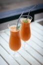 Selective Focus Photography of Two Orange Drinks