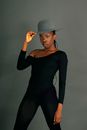 Woman in Black Long Sleeve Shirt and Black Pants Wearing Gray Fedora Hat