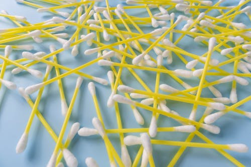 Free Close-Up Shot of Cotton Buds on Blue Surface Stock Photo