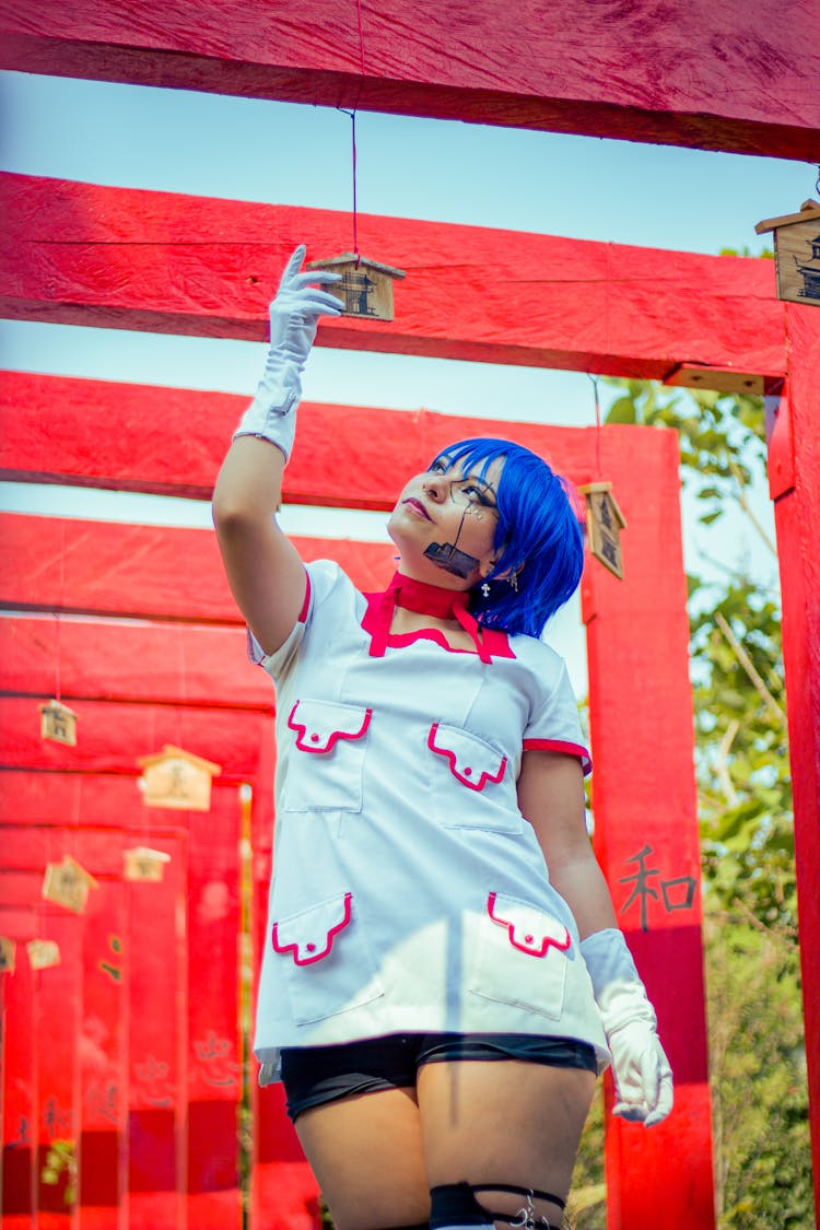 Girl In Eccentric Clothes With Blue Hair In Park