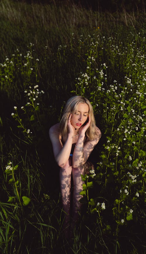 Beautiful Woman Sitting on Flower Field