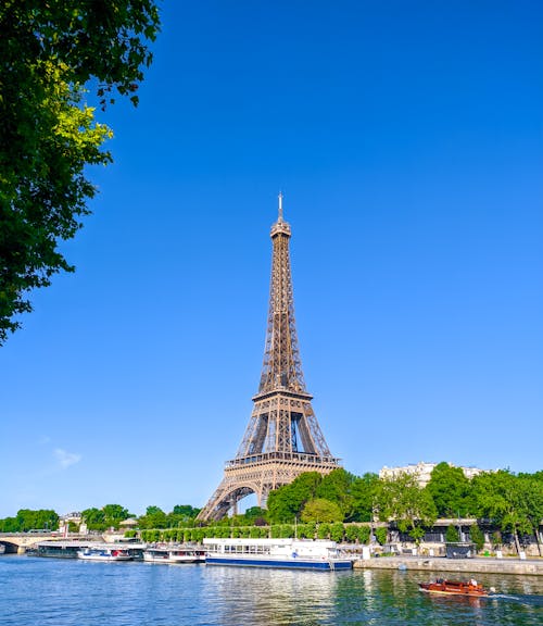 Free Eiffel Tower Under Blue Sky Near a Body of Water Stock Photo