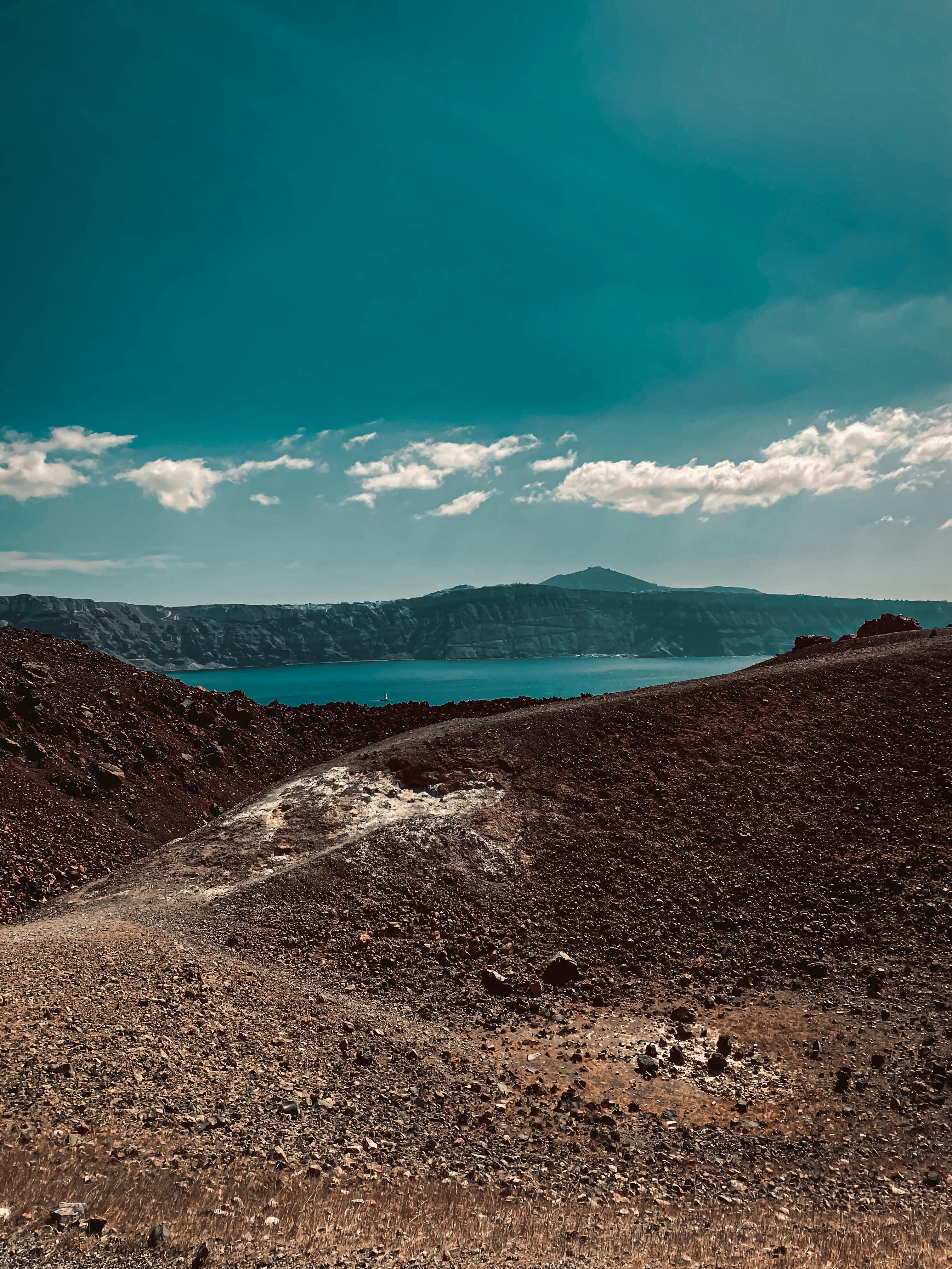 Body of Water in a Valley Surrounded by Mountains · Free Stock Photo