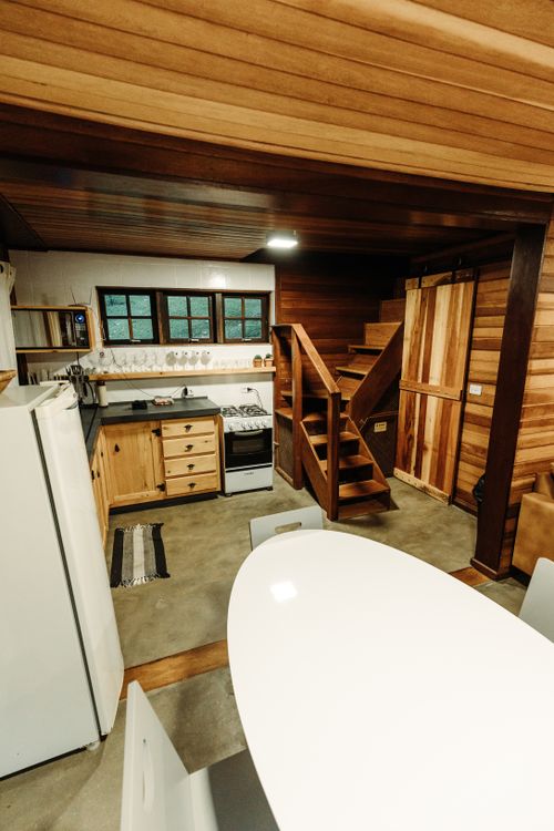 Free A warm and inviting kitchen with wooden decor and a functional open floor plan. Stock Photo