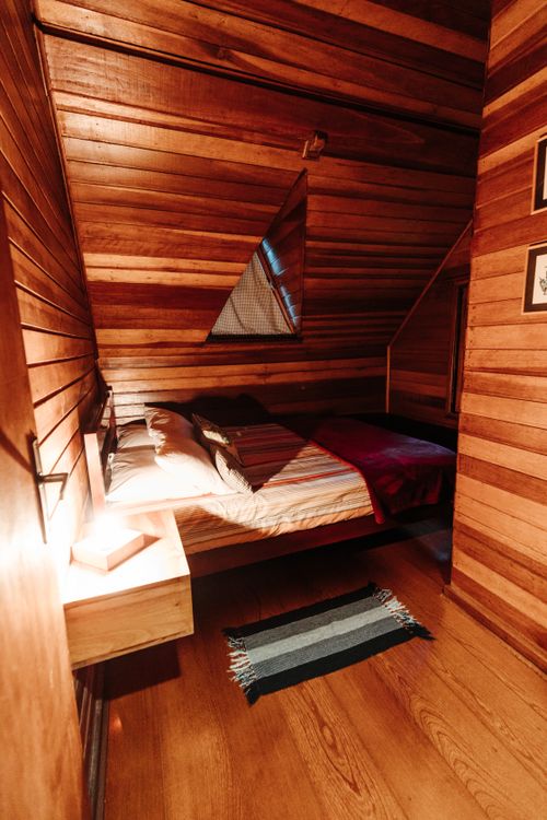 Free Cozy wooden bedroom with ambient lighting in a cabin-style room Stock Photo