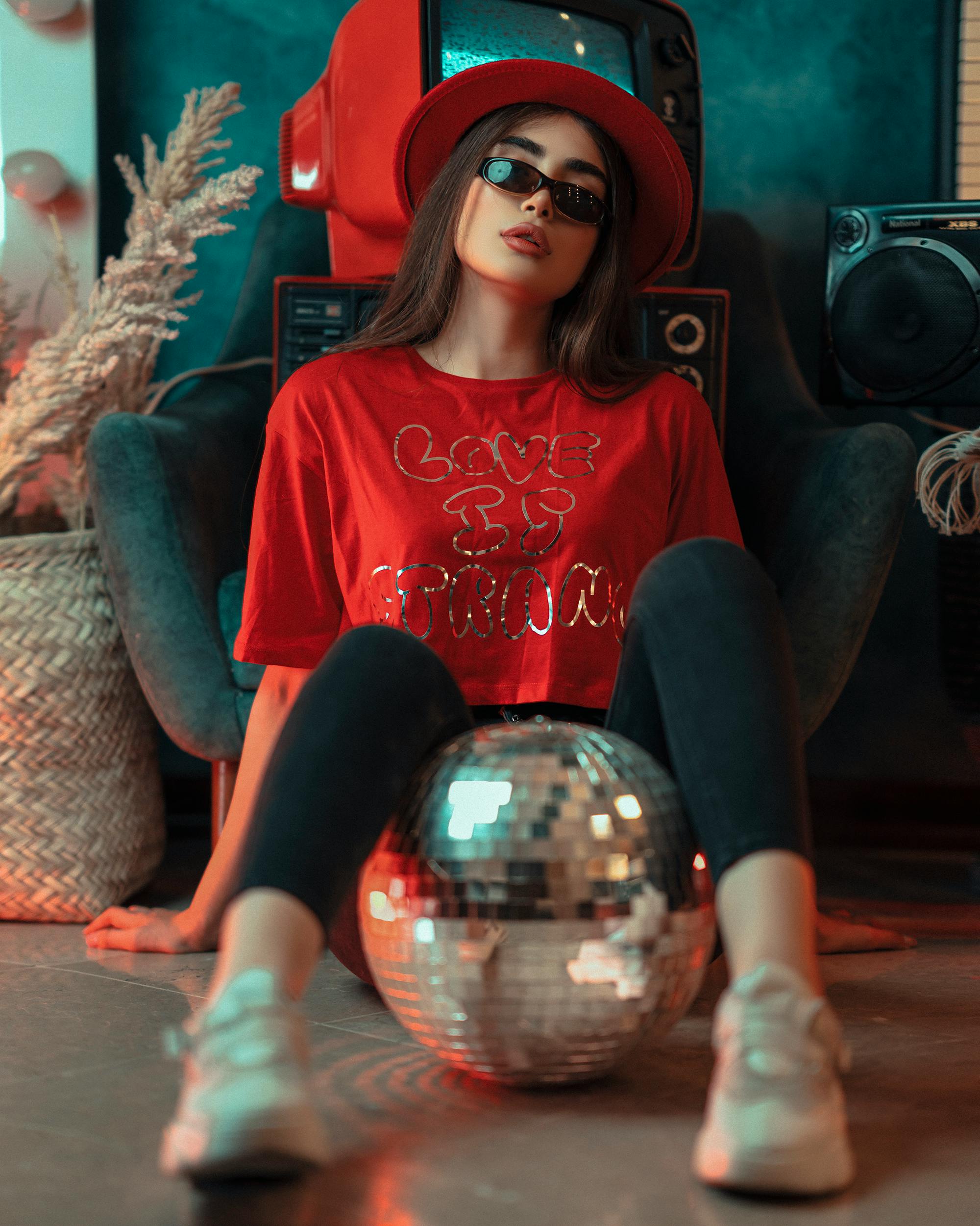 woman sitting with a disco ball between her legs