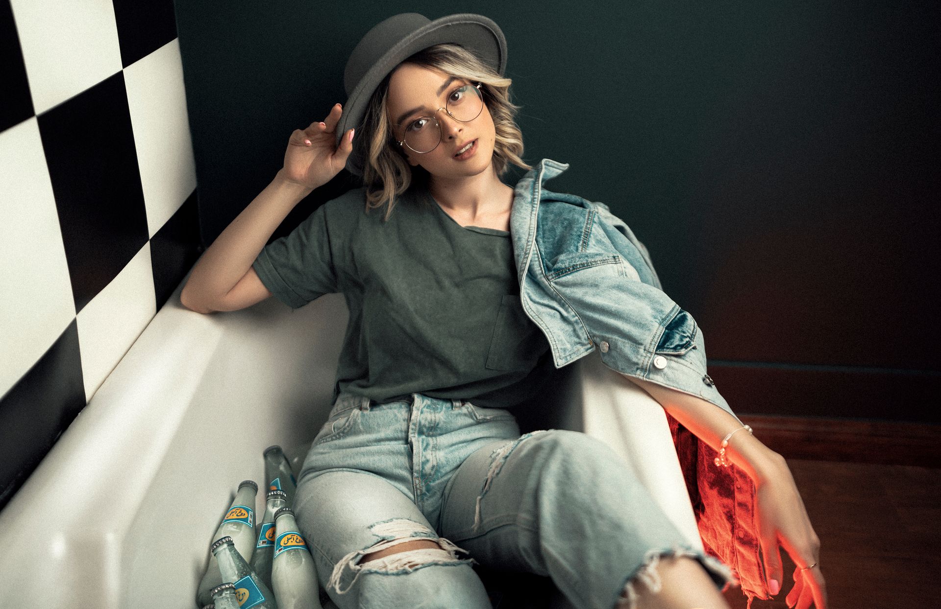 Woman Sitting in a Bathtub Fully Clothed