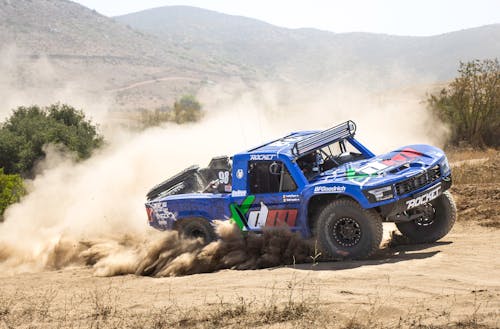 Blue Pickup Truck on Dirt Road